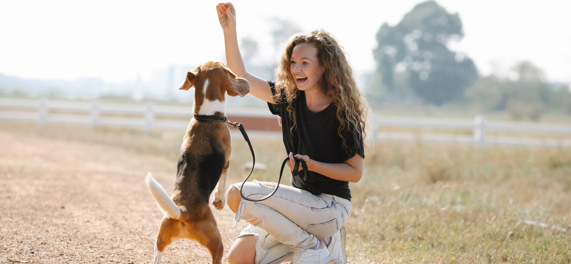 Girl training a dog.